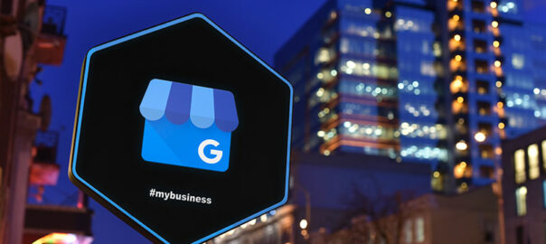 A sign board that indicates Google My Business symbol placed before a tall building.